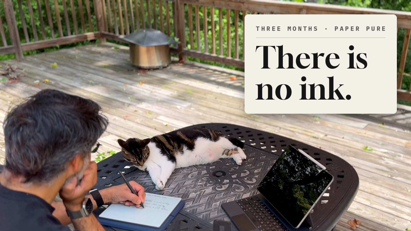 Writing on the reMarkable Paper Pure at a patio table on the deck while Bunny the cat watches the pen, an iPad beside them
